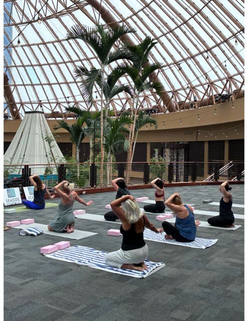 Yoga class on mats beneath the glass dome at Harrah's